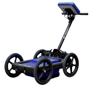 Blue and black four-wheeled cart with a tall handle and a mounted screen/controller on the handle.